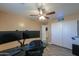 Comfortable bedroom with plank floors, ceiling fan, and natural light, ideal for relaxation and productivity at 20867 N Grantham Rd, Maricopa, AZ 85138