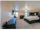A well lit bedroom with windows, plush carpet, and dark furniture at 20867 N Grantham Rd, Maricopa, AZ 85138