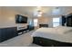 Spacious bedroom with large bed, television, windows, and storage furniture at 20867 N Grantham Rd, Maricopa, AZ 85138