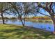 Scenic view of the tranquil community lake in the Homestead community with mature trees and bird life at 20867 N Grantham Rd, Maricopa, AZ 85138