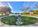 Community park and grill area with walking paths and a lake with mature trees in the Homestead community at 20867 N Grantham Rd, Maricopa, AZ 85138