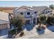 Well-maintained two-story home with a clean desert landscape and a three car garage at 20867 N Grantham Rd, Maricopa, AZ 85138