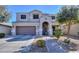 Inviting two-story home with a well-maintained front yard, arched entryway, and a two-car garage at 20867 N Grantham Rd, Maricopa, AZ 85138