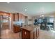 Open kitchen with an island that includes bar stool seating, tile floors, and modern finishes at 20867 N Grantham Rd, Maricopa, AZ 85138