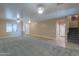 Large living room with neutral colors, a staircase, and access to other rooms at 20867 N Grantham Rd, Maricopa, AZ 85138