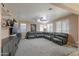 Spacious living room featuring a large sectional couch, neutral paint, and ample natural light at 20867 N Grantham Rd, Maricopa, AZ 85138
