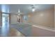 Spacious carpeted living room with a view of an adjoining kitchen area, great for entertaining at 20867 N Grantham Rd, Maricopa, AZ 85138
