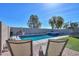 A pristine pool and lounge chairs create a relaxing backyard oasis at 20867 N Grantham Rd, Maricopa, AZ 85138