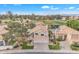 Aerial view of a home with a three-car garage, tile roof, golf course and water views at 2158 W Peninsula Cir, Chandler, AZ 85248