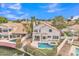Aerial view of a home with a backyard swimming pool and scenic lake setting at 2158 W Peninsula Cir, Chandler, AZ 85248