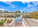 Scenic backyard with a tranquil lake view, framed by lush greenery and a charming brick border at 2158 W Peninsula Cir, Chandler, AZ 85248