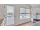 Bright bedroom with golf course and lake views, featuring wood floors, a window, and a door to the balcony at 2158 W Peninsula Cir, Chandler, AZ 85248