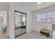 Minimalist bedroom featuring a mirrored closet and a window offering natural light at 2158 W Peninsula Cir, Chandler, AZ 85248