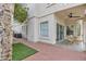 Charming home exterior featuring a covered patio, brick walkway, and well-maintained landscaping at 2158 W Peninsula Cir, Chandler, AZ 85248