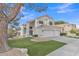 Charming two-story home featuring a tile roof, stucco exterior, and well-maintained artificial lawn at 2158 W Peninsula Cir, Chandler, AZ 85248