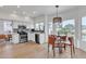 Bright kitchen with stainless steel appliances, white cabinets, and adjacent eat-in area at 2158 W Peninsula Cir, Chandler, AZ 85248