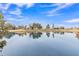 Picturesque lake view showcasing a serene body of water with surrounding golf course and trees at 2158 W Peninsula Cir, Chandler, AZ 85248