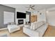 Comfortable living room featuring a fireplace, ceiling fan, and plush seating at 2158 W Peninsula Cir, Chandler, AZ 85248