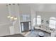 Bright living room with a modern sofa, statement lighting, and a welcoming entryway at 2158 W Peninsula Cir, Chandler, AZ 85248