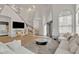 Bright living room with high ceilings, modern staircase, and stylish white sofas at 2158 W Peninsula Cir, Chandler, AZ 85248