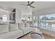 Open-concept living room with a view to the pool, hardwood floors, and modern white sofa at 2158 W Peninsula Cir, Chandler, AZ 85248