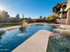 Inviting backyard pool with water features and desert landscaping, perfect for relaxing or entertaining at 2158 W Peninsula Cir, Chandler, AZ 85248