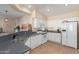 Bright kitchen with white cabinets, modern appliances, and a breakfast bar for casual dining at 21772 N Limousine Dr, Sun City West, AZ 85375