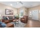 Inviting living room with ample seating, a ceiling fan, and warm wood-look floors at 21772 N Limousine Dr, Sun City West, AZ 85375