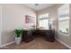 Office with a classic dark wood desk, neutral walls, and plenty of natural light from the window at 21772 N Limousine Dr, Sun City West, AZ 85375