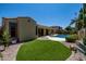 Beautiful backyard with lush green lawn, sparkling pool, and covered patio, creating an ideal outdoor oasis at 21842 E Via De Olivos --, Queen Creek, AZ 85142