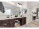 Bright bathroom featuring a double sink vanity, large mirrors, and modern finishes at 21842 E Via De Olivos --, Queen Creek, AZ 85142