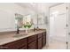 Well-lit bathroom with double sinks, granite counters, and a view to the bath and shower at 21842 E Via De Olivos --, Queen Creek, AZ 85142