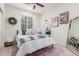 Comfortable bedroom with a decorative wreath and a view into the well-lit bathroom at 21842 E Via De Olivos --, Queen Creek, AZ 85142