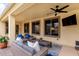 Relaxing covered patio featuring comfortable seating and a ceiling fan, ideal for lounging and enjoying the outdoors at 21842 E Via De Olivos --, Queen Creek, AZ 85142