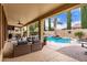 Relaxing covered patio with comfortable seating overlooking the private pool and garden at 21842 E Via De Olivos --, Queen Creek, AZ 85142