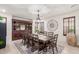Elegant dining room with large table, stylish chandelier, and custom built-ins at 21842 E Via De Olivos --, Queen Creek, AZ 85142