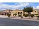 Attractive single-story home with a three-car garage, desert landscaping, and appealing architectural details at 21842 E Via De Olivos --, Queen Creek, AZ 85142