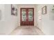 Warm foyer with stylish double doors, neutral tile flooring, and elegant decor at 21842 E Via De Olivos --, Queen Creek, AZ 85142