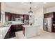Modern kitchen boasts stainless steel appliances, dark wood cabinetry, granite countertops, and a center island at 21842 E Via De Olivos --, Queen Creek, AZ 85142