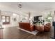 Bright, open living room with hardwood floors, statement chandelier, and neutral decor at 21842 E Via De Olivos --, Queen Creek, AZ 85142