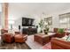 Spacious living room with hardwood floors, comfortable brown leather seating, and a large-screen TV at 21842 E Via De Olivos --, Queen Creek, AZ 85142
