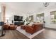 Inviting living room featuring hardwood floors, a large TV, comfortable seating, and stylish decor at 21842 E Via De Olivos --, Queen Creek, AZ 85142