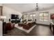 Bright living room with hardwood floors, comfortable seating, and a large entertainment center for modern living at 21842 E Via De Olivos --, Queen Creek, AZ 85142