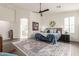 Serene main bedroom with ceiling fan, large rug, and doorway to the en-suite bathroom and walk-in closet at 21842 E Via De Olivos --, Queen Creek, AZ 85142