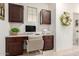 Home office featuring upper and lower cabinetry with a built-in desk and a window at 21842 E Via De Olivos --, Queen Creek, AZ 85142