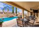 Covered patio featuring a dining table set and an outdoor seating area overlooking the pool at 21842 E Via De Olivos --, Queen Creek, AZ 85142
