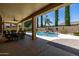 Inviting covered patio overlooking a private pool and landscaped backyard with waterfall feature at 21842 E Via De Olivos --, Queen Creek, AZ 85142