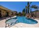 Stunning pool with a waterfall feature, surrounded by lush landscaping and a covered patio, offering a private retreat at 21842 E Via De Olivos --, Queen Creek, AZ 85142