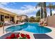 Inviting backyard pool with rock waterfall feature, lush landscaping, and comfortable lounge area for relaxation and enjoyment at 21842 E Via De Olivos --, Queen Creek, AZ 85142