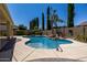 Beautiful pool area with mature landscaping, a rock waterfall, and a spacious deck, providing a tranquil outdoor space at 21842 E Via De Olivos --, Queen Creek, AZ 85142